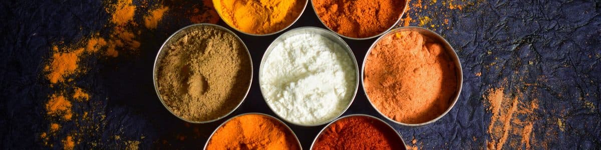 Bowls of curry and spice powders — seasoning flavours OEM manufactured by D&O Nutraceutical in Malaysia