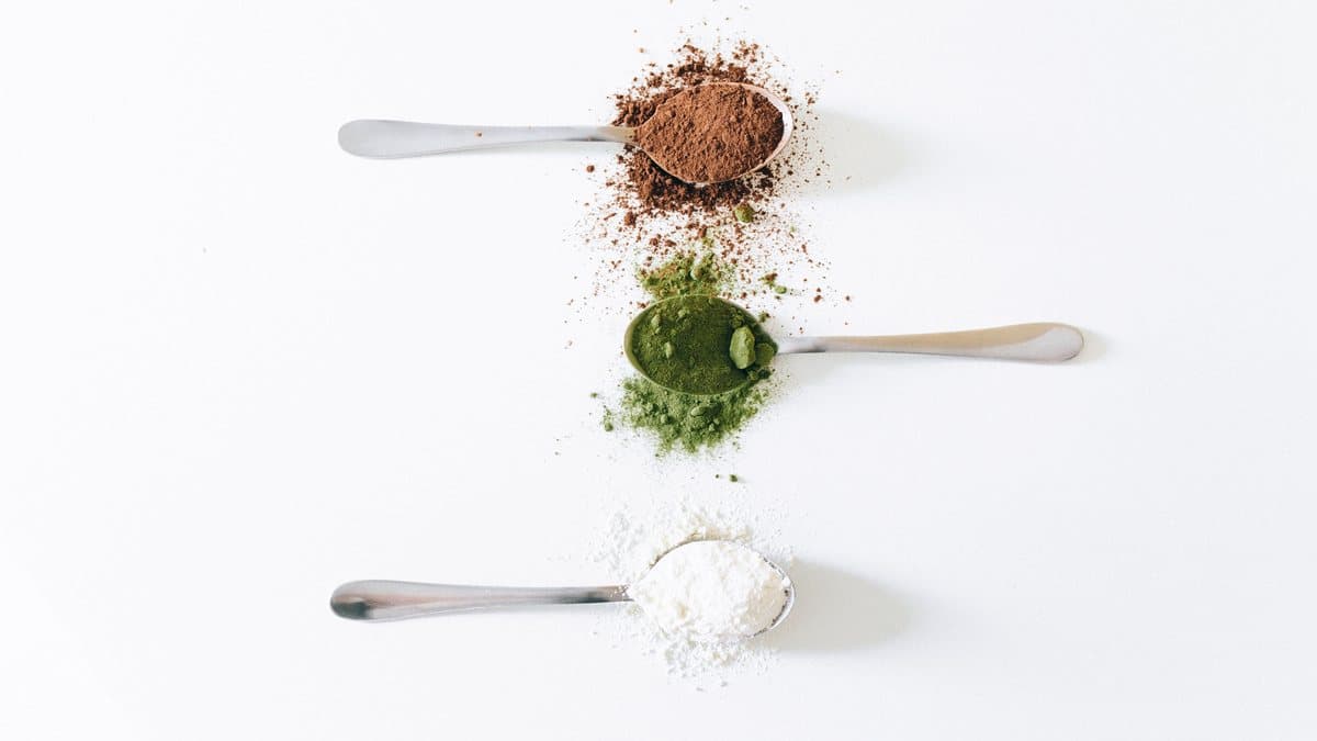 Cocoa, matcha and milk powders measured out — OEM instant powder manufacturing