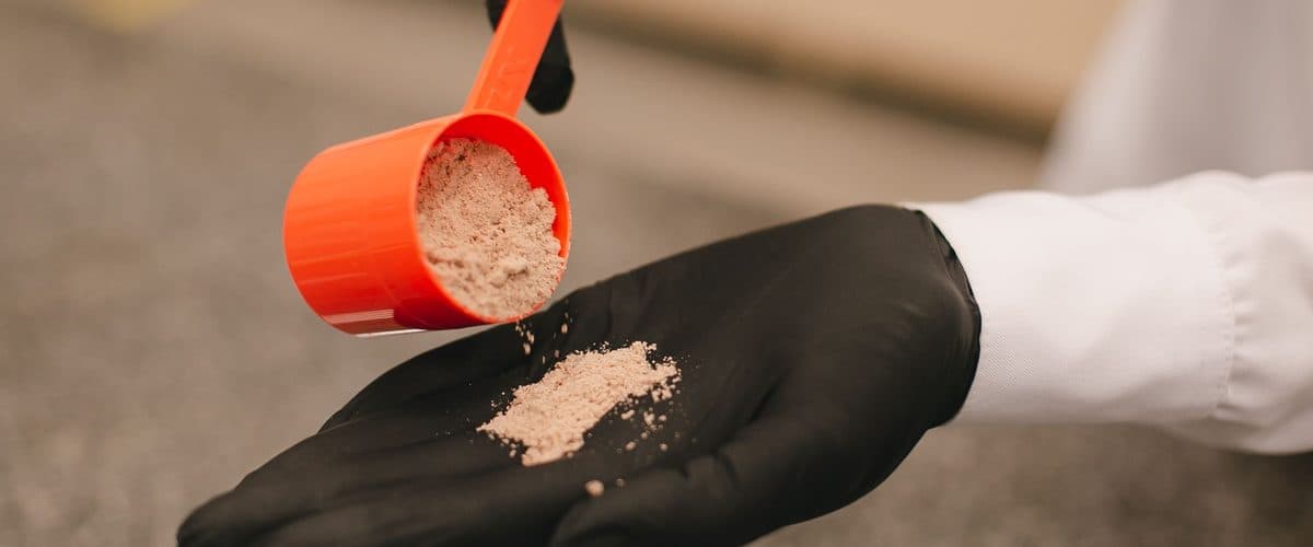 Weighing out a powder blend by hand — OEM powder manufacturing